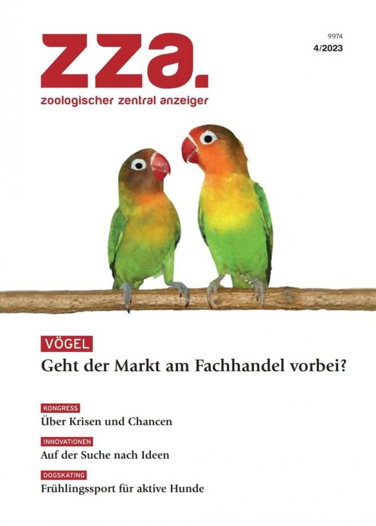 Zwei bunte Unzertrennliche sitzen sich auf einem Ast gegenüber auf dem Titelblatt einer deutschen Zoologiezeitschrift